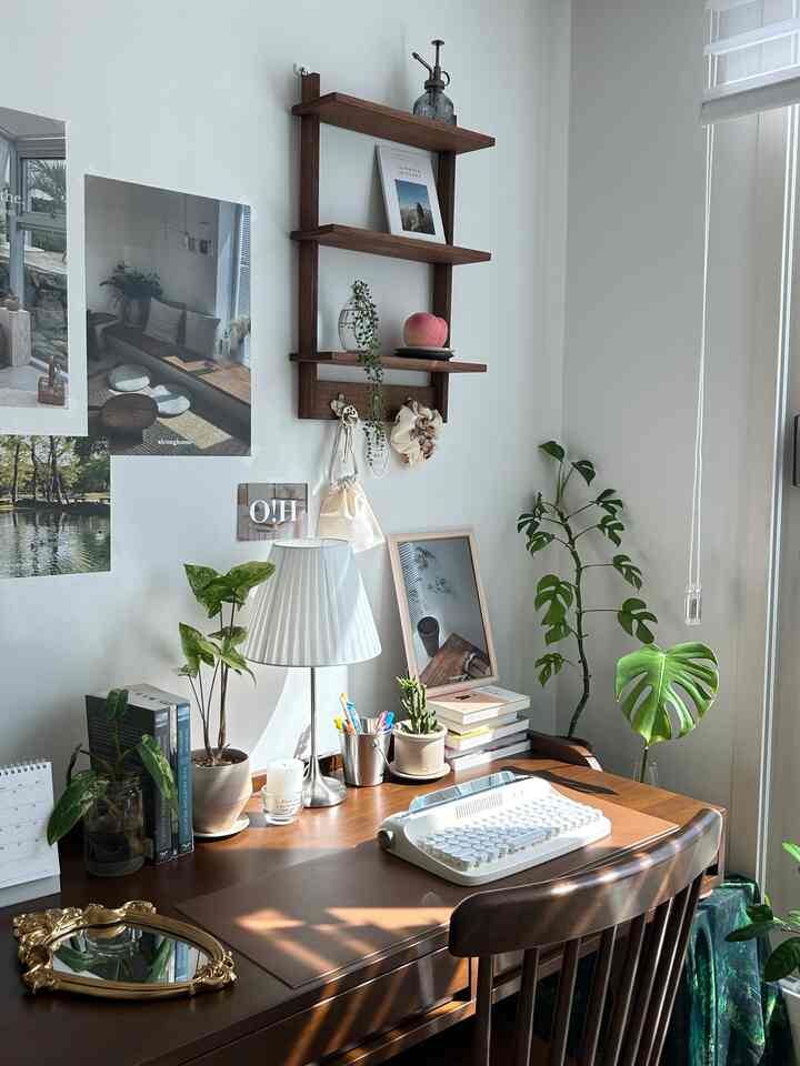 白と木目調の調和が取れたホームオフィス、木製のデスクと椅子、植物が落ち着いた雰囲気を演出している