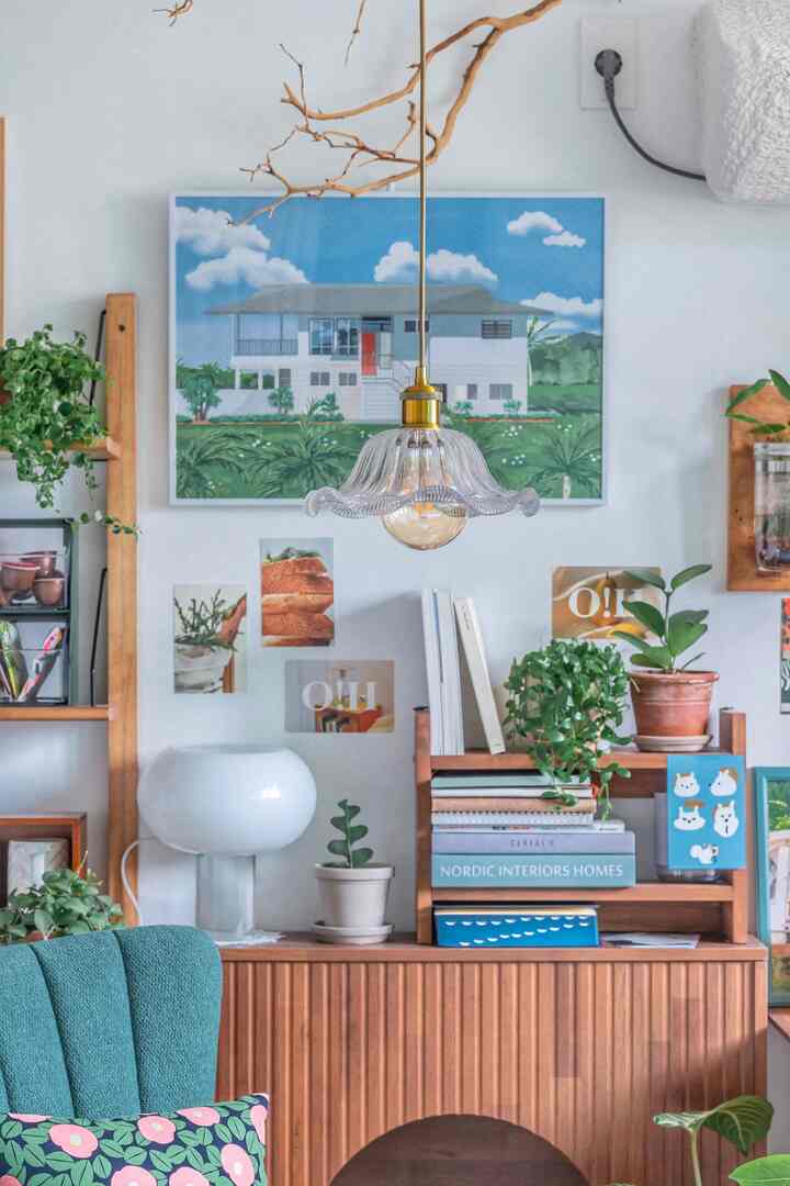 Natural study featuring transparent glass pendant light and lush plants with cozy atmosphere