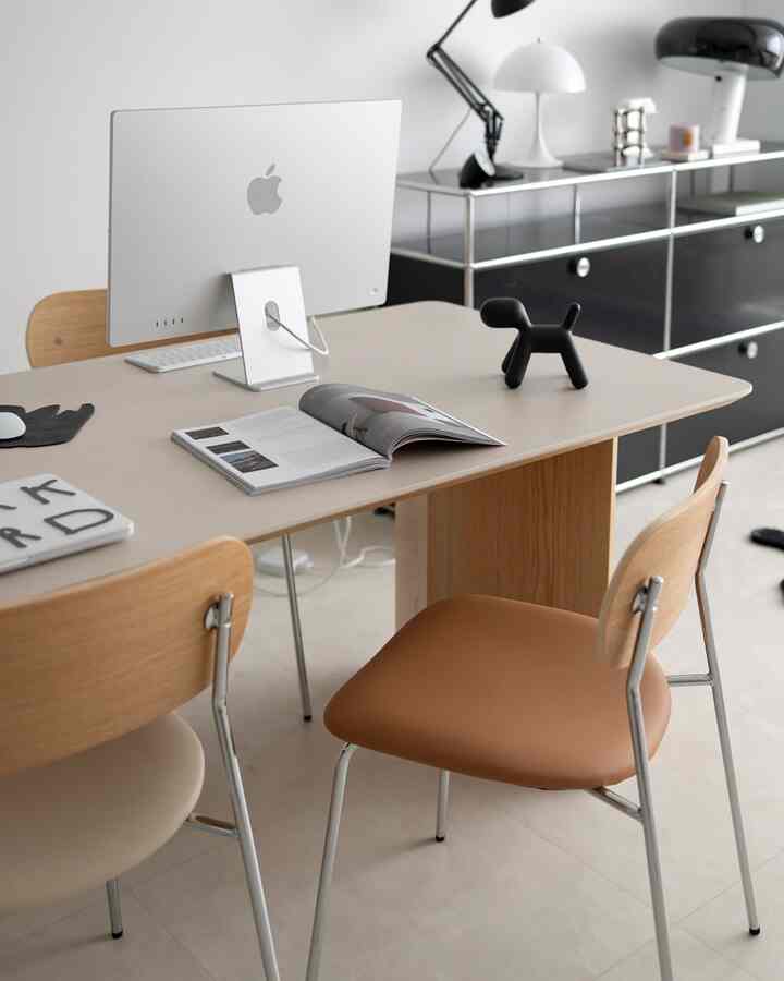 White and brown toned home office featuring desk and chairs with a modern minimalistic atmosphere