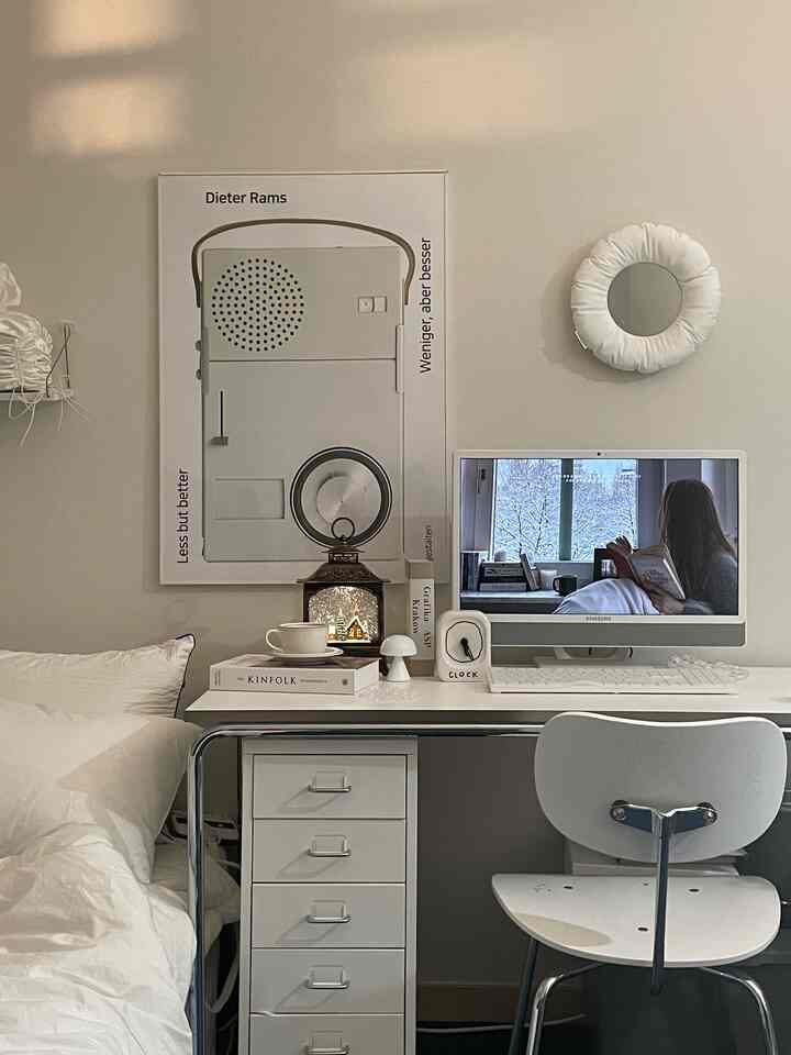 Soft white-toned home office space featuring a minimalist desk with assorted desk accessories, creating a cozy atmosphere