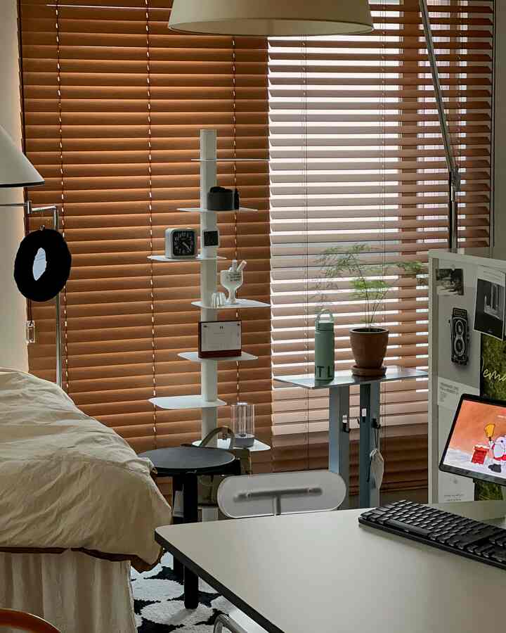 Natural wood-tone blinds backdrop with bed and desk included, creating a modern bedroom combined with home office space