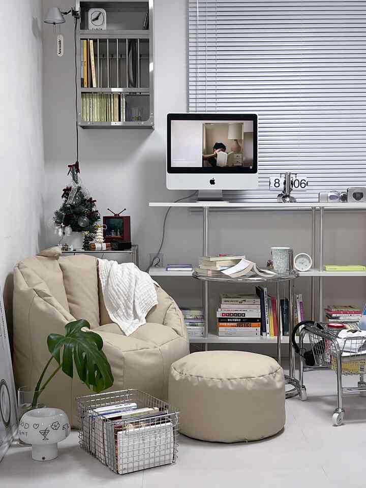 Beige-toned compact study featuring a bean bag sofa, stool, and bookshelf in a cozy interior
