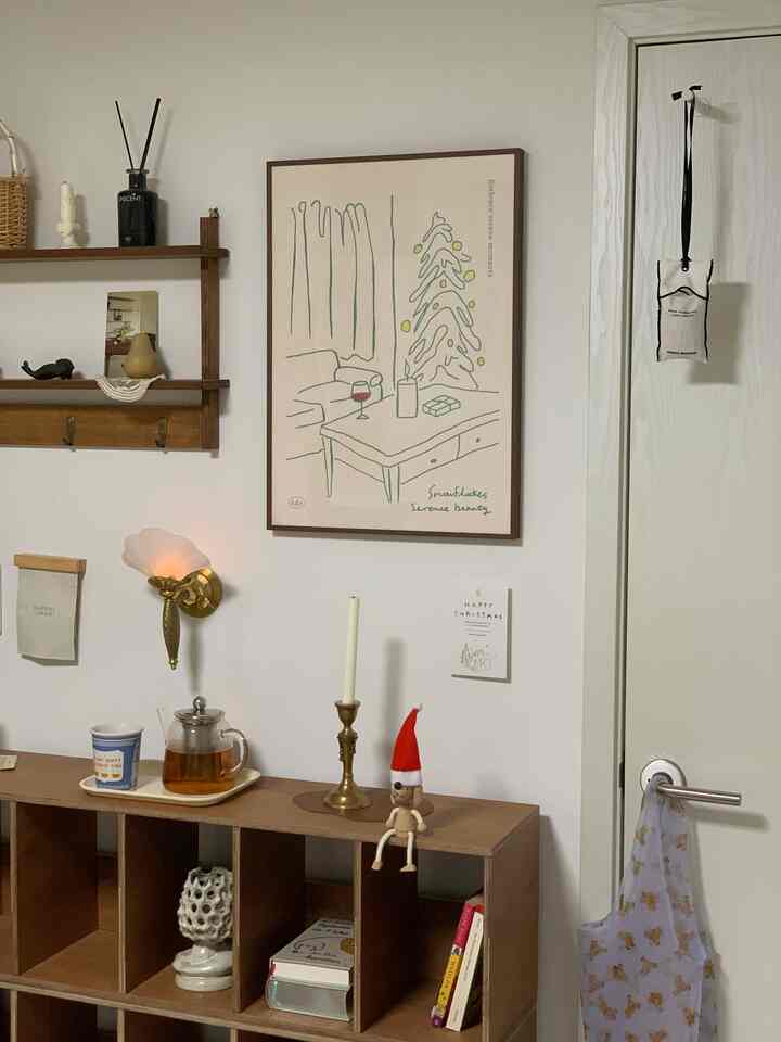 White and brown wood tone single household space featuring Christmas poster and decorative objets with a cozy atmosphere