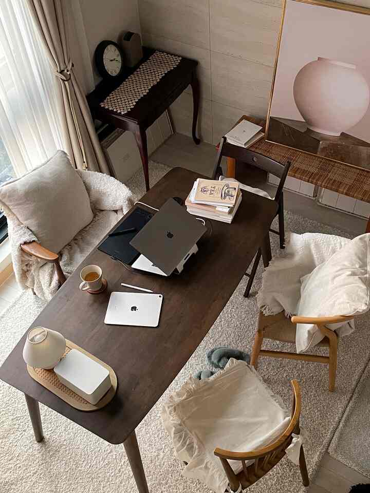 Natural brown toned dining room featuring a home office and study setup with cozy atmosphere