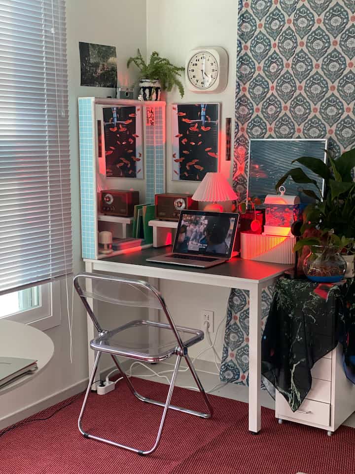 Red rug and patterned wallpaper home office desk space featuring retro decor and companion lighting ambiance