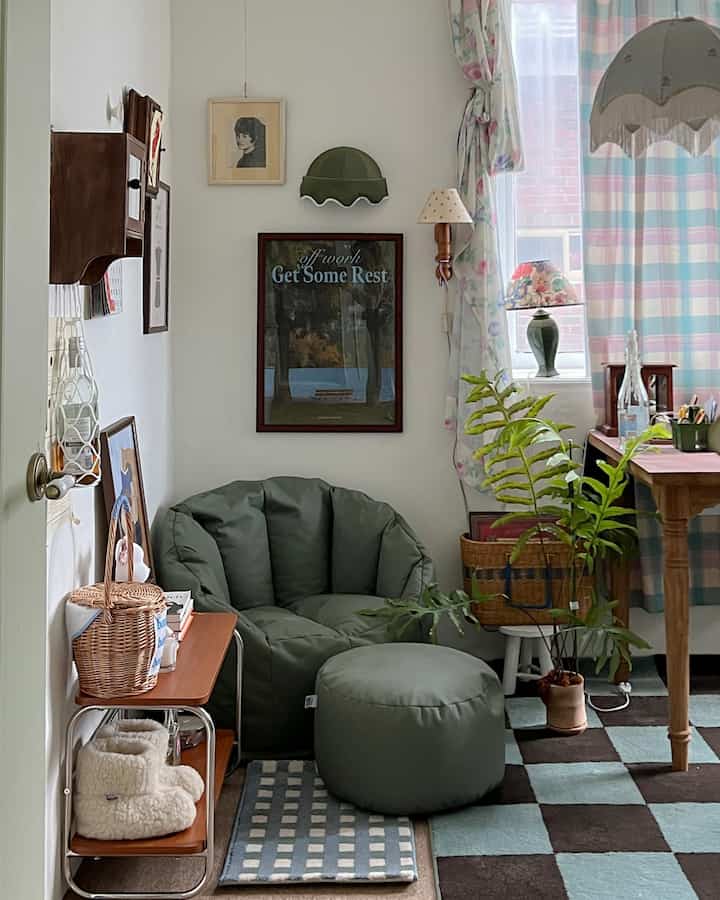 Olive green toned living room featuring a bean bag sofa and stool, plants, and vintage decor creating a cozy atmosphere