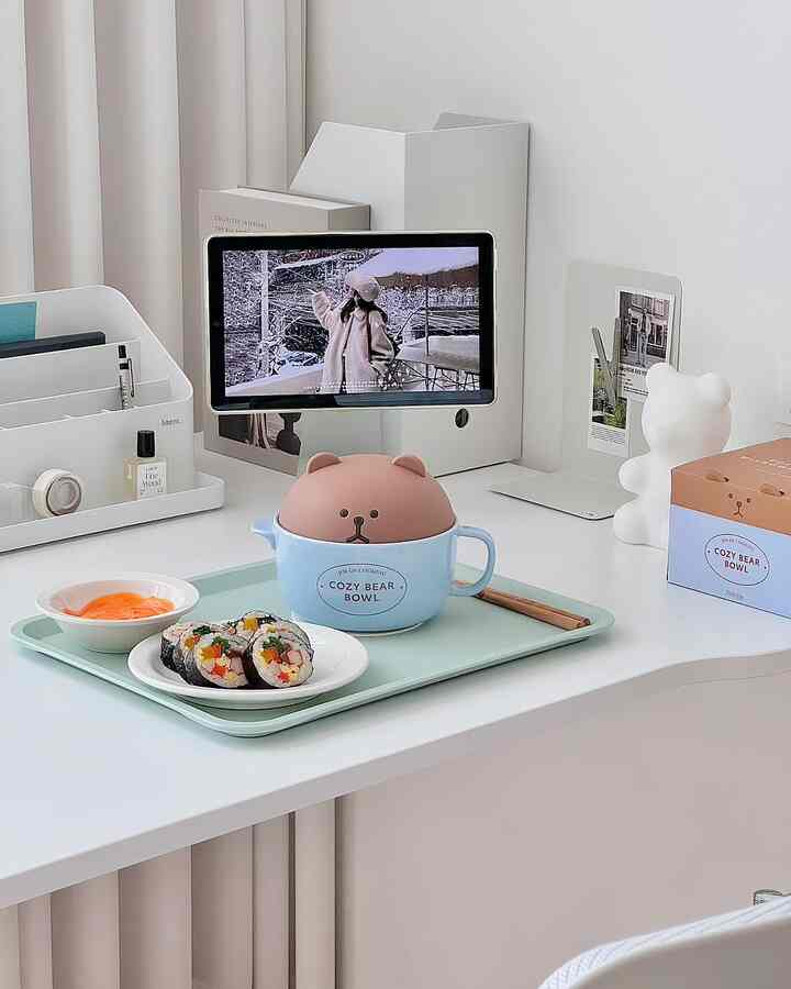 Clean and cozy home office desk in white and mint tones featuring kimbap and a cute bear-shaped bowl