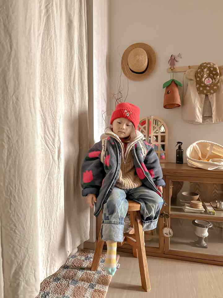 A natural beige and wood tone kids' room featuring cozy curtains and playful accessories