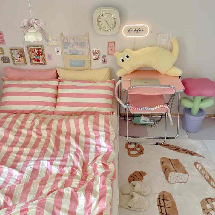 A cozy 6-tatami bedroom in pink and beige tones featuring a cute plush toy and folding chair in a home office setup