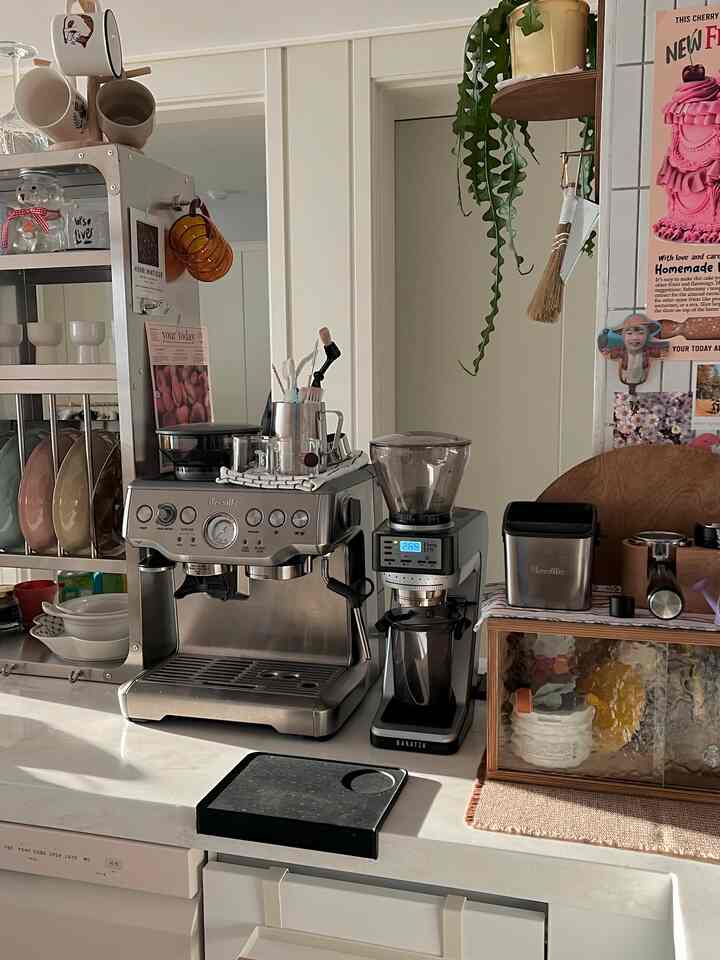 Kitchen space featuring silver metallic and wood tones with Breville home cafe equipment and a mini nookbox, creating a cozy atmosphere