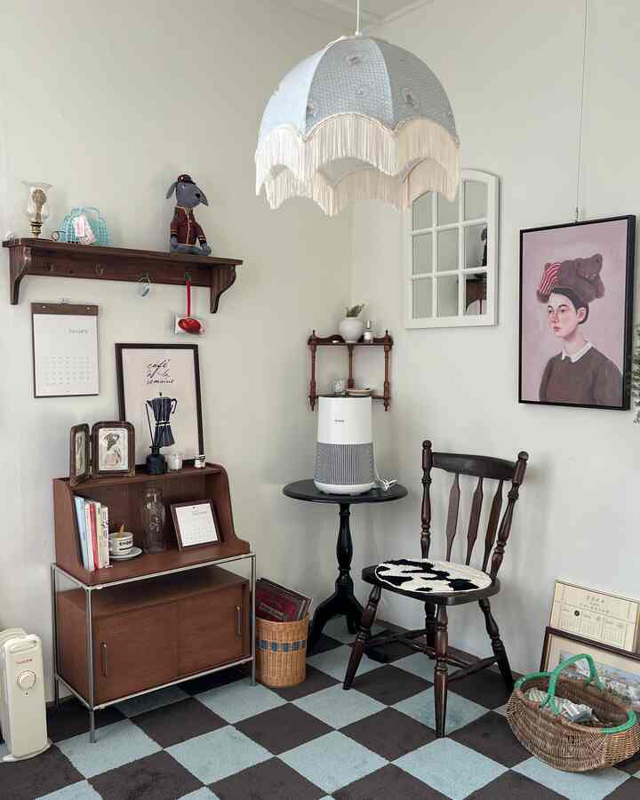 White and brown toned living room featuring vintage wood furniture and a checkered rug creating a cozy atmosphere