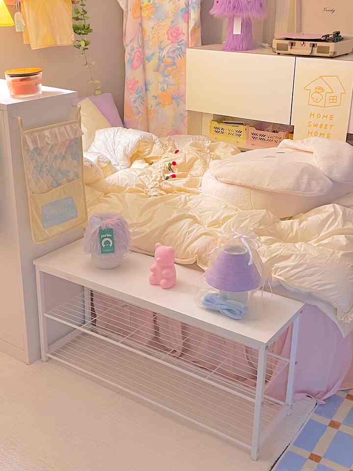 Pastel and white toned bedroom featuring cozy bedding and shelf, creating an aesthetic and comfortable interior space