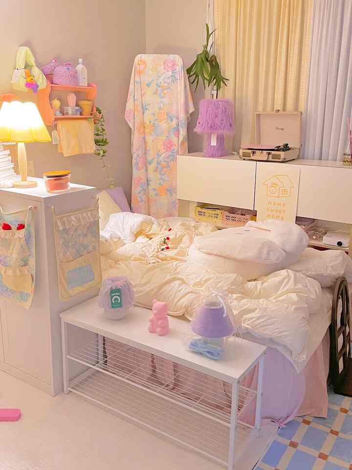 Cozy small bedroom in soft beige and pastel tones featuring a central bed and assorted lamps