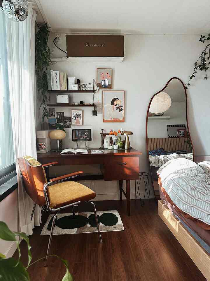 Cozy studio bedroom with warm wood tones and natural vibe, featuring a desk and armchair