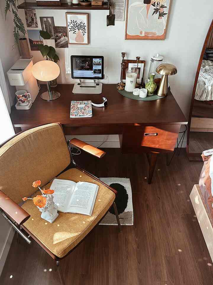 Natural brown-tone bedroom and home office featuring a wooden desk and yellow armchair in a cozy setting
