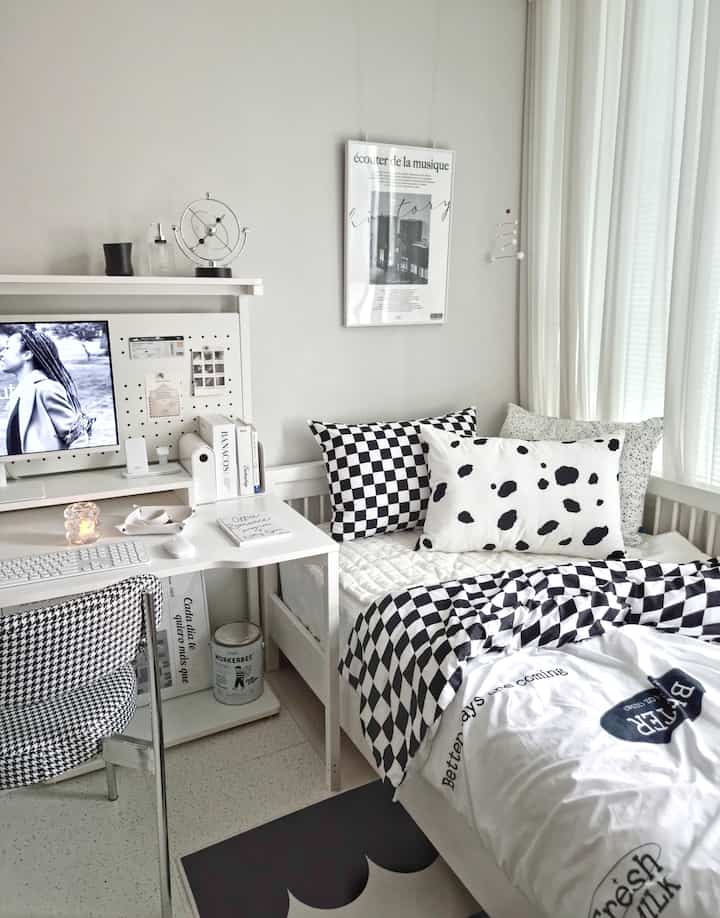 White and black toned kids' room featuring mid-century modern bed and desk creating a neat study space