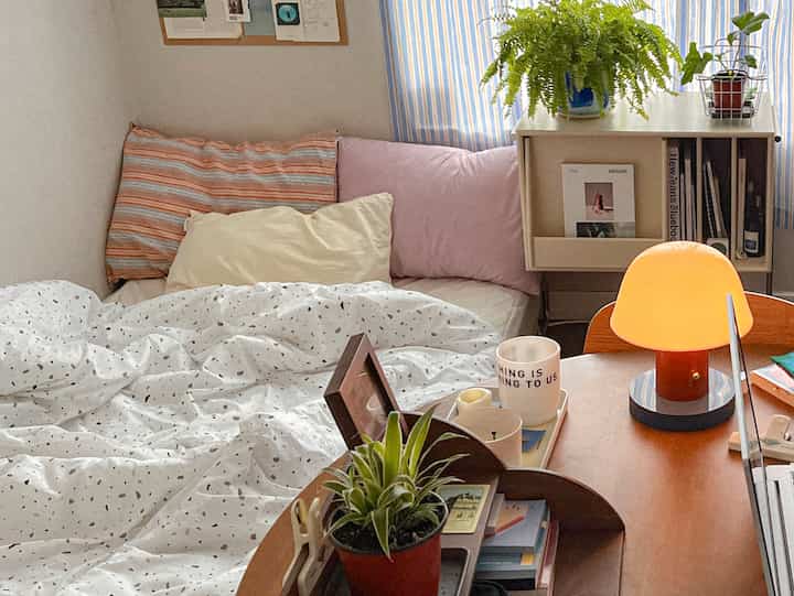 White and brown toned bedroom featuring bed and desk arranged with a cozy natural atmosphere