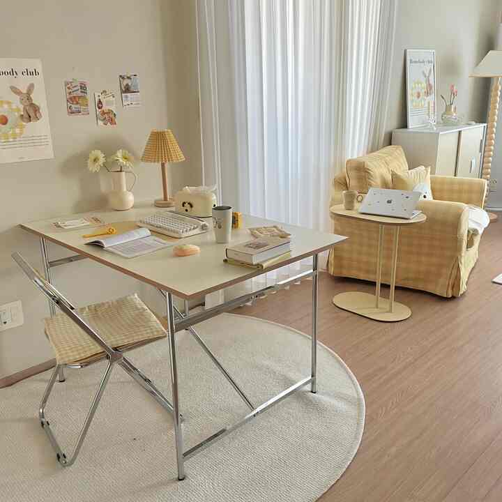 Pastel and yellow toned living room featuring a sturdy steel table and check-patterned sofa creating a cozy atmosphere