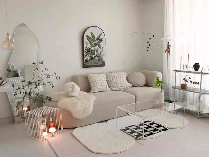 Beige-toned living room featuring a beige sofa and white rug centrally arranged, creating a simple and natural atmosphere