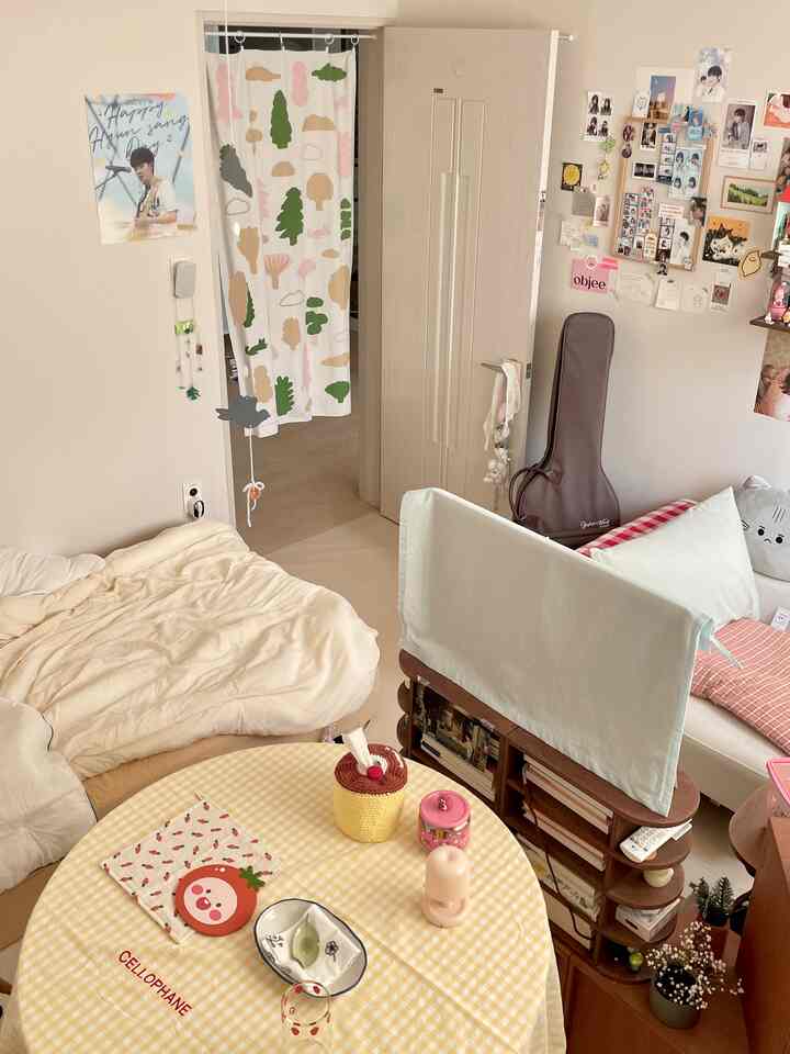 Warm beige and natural toned bedroom with sofa and table in a cozy single-room space
