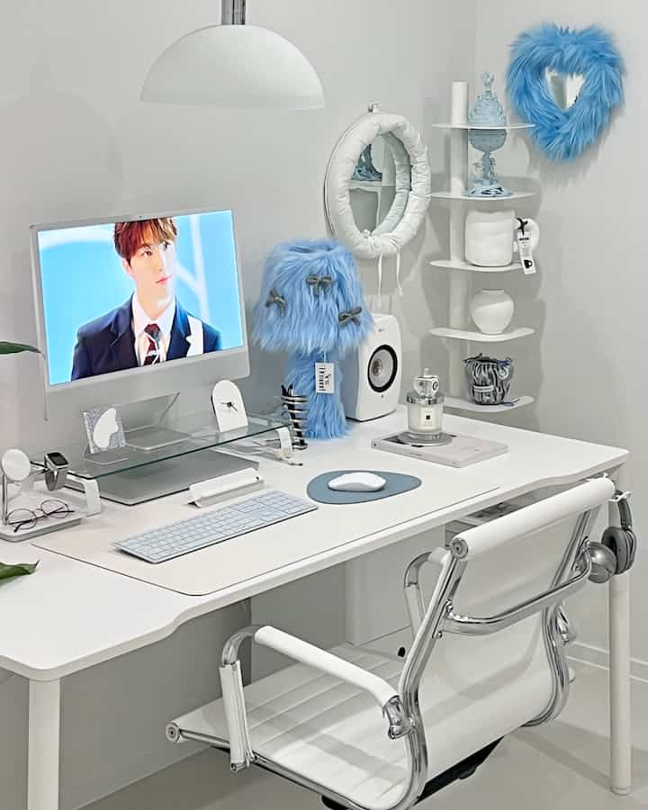 White and sky blue toned home office space featuring clean desk and office chair with simple, modern desk interior