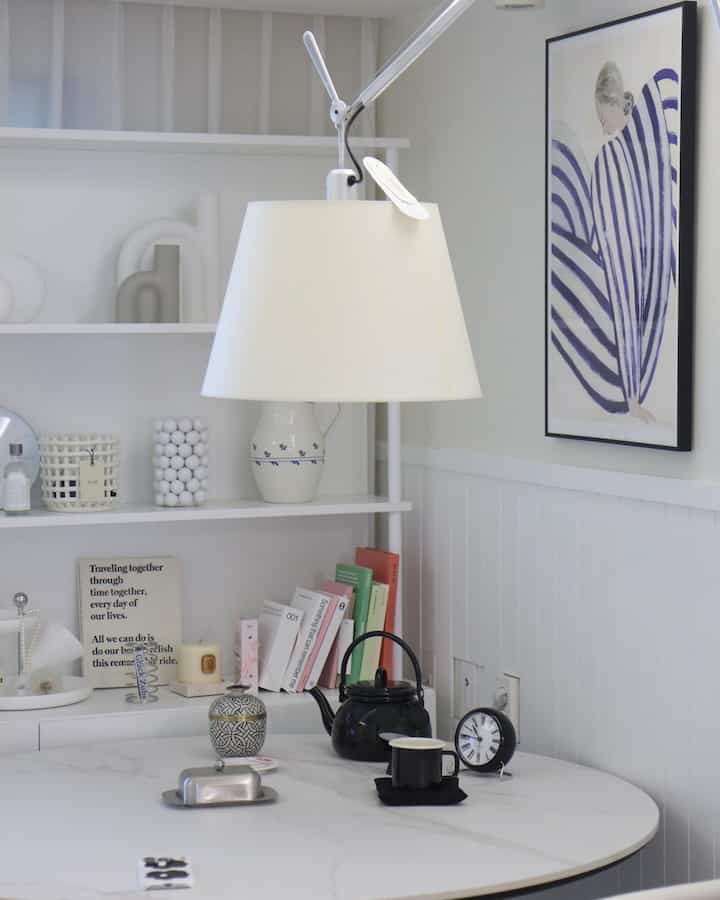 White and black tone dining room featuring round table and kitchenware with simple and natural atmosphere