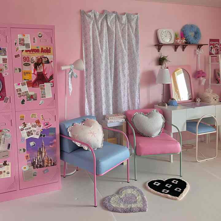 A pink and blue toned single household room featuring heart-shaped cushions and rugs in a charming high-teen interior space