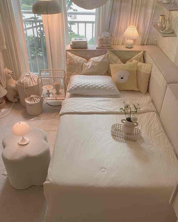 ベージュとナチュラルな色調の居心地良い寝室、枕とフロアランプが配置されたミニマルな空間