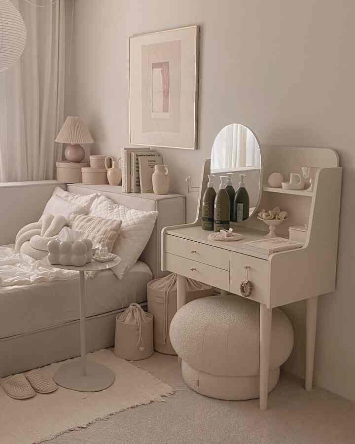 アイボリーとベージュのトーンの寝室、化粧台とふわふわのスツールが配置された雰囲気のあるインテリア