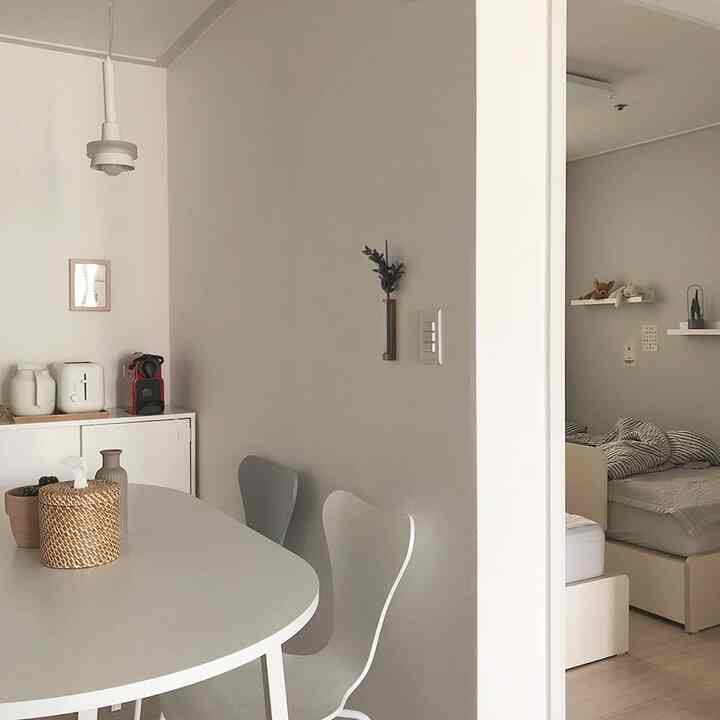 White and beige toned kitchen linked to kids' bedroom, a simple and natural space for a two-person household