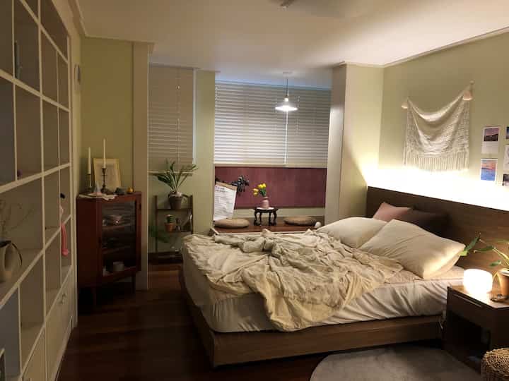 Beige and wood-toned bedroom featuring custom furniture and blinds creating a cozy atmosphere