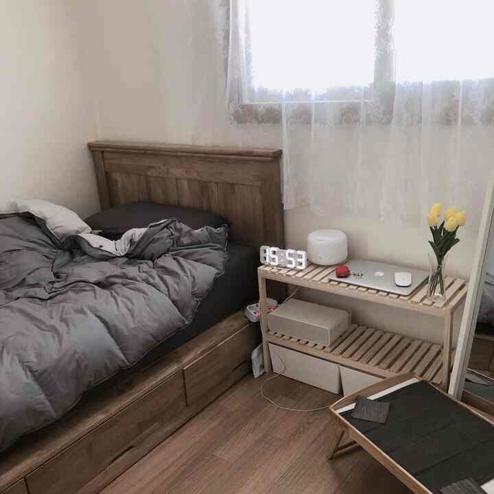 Calm wood tone natural bedroom featuring a wooden bed and nightstand creating a cozy atmosphere