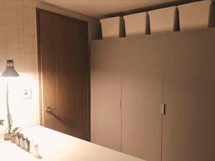 White and brown toned walk-in closet featuring large wardrobes with a clean and simple atmosphere