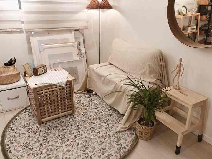 Natural color and wood tone workspace featuring beige sofa, stool, and wooden furniture arranged neatly with cozy atmosphere