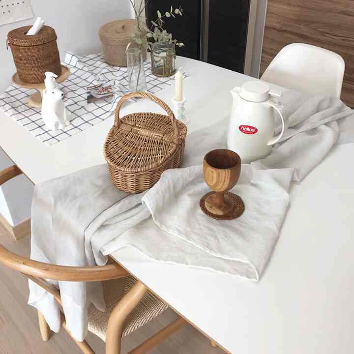 Natural-toned dining space featuring rattan baskets and wooden accessories with a clean and cozy atmosphere