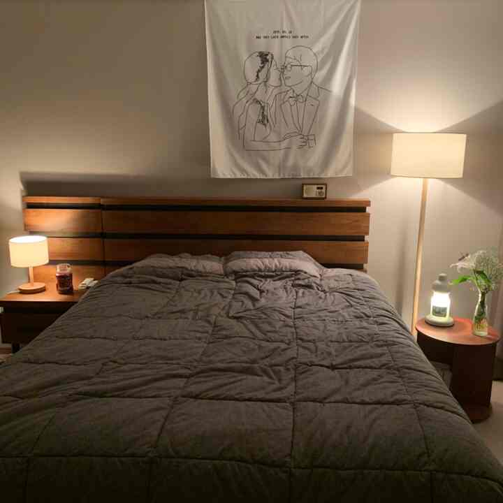 Natural brown toned bedroom featuring wooden bed and nightstands with warm ambient lighting creating cozy atmosphere