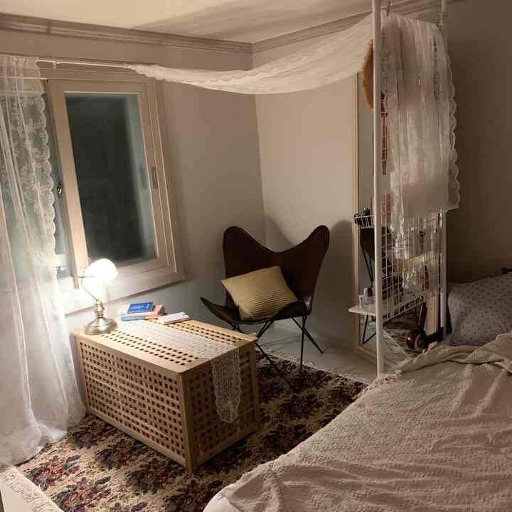 Beige and natural toned studio bedroom featuring IKEA curtains and partitions creating a cozy, well-organized space