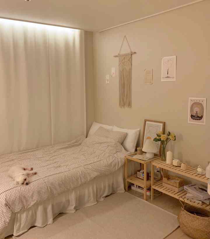 Natural color toned bedroom with bed, wooden storage shelves, and soft indirect lighting creating calm atmosphere