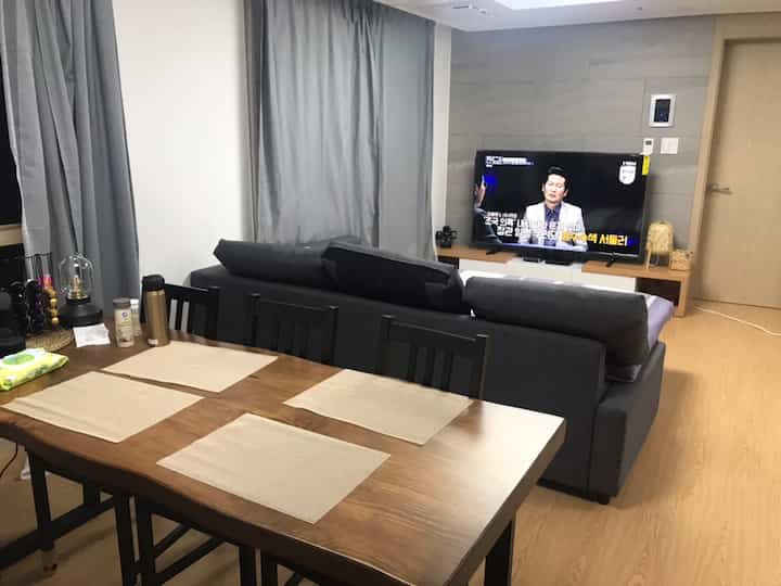 Gray and black toned living and dining area featuring modern IKEA furniture in a neat newlywed home