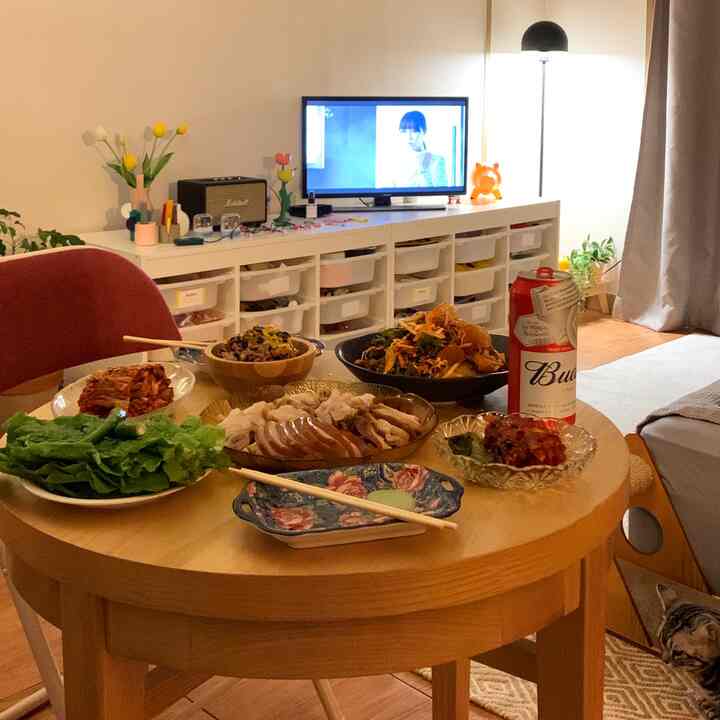Wood-toned and black accented living room featuring round dining table and vintage decor creating a cozy atmosphere