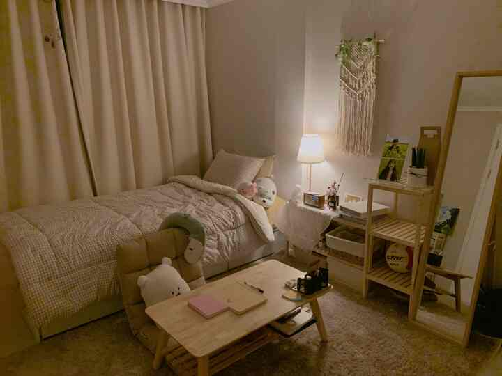 Cozy beige-toned bedroom featuring natural wood furniture and warm lighting creating a comfortable atmosphere