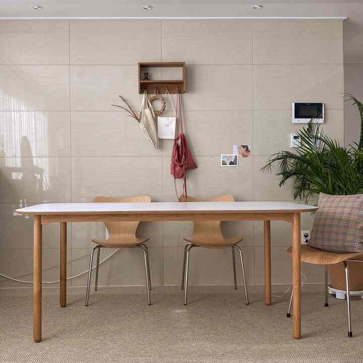 Beige-toned dining room with natural wood dining table and chairs in a natural modern style