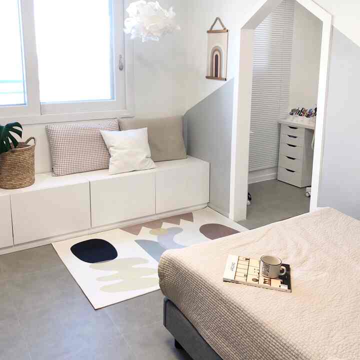 Beige and white toned kids' room featuring study and sleeping areas with simple natural interior design