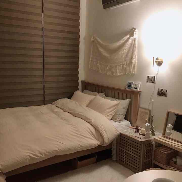 Cozy bedroom featuring soft beige tones and natural wood furniture with warm ambient lighting