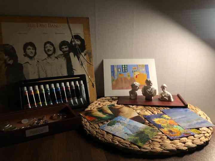 Natural warm-toned dresser top featuring Van Gogh artworks and plaster objets in a cozy home gallery setup