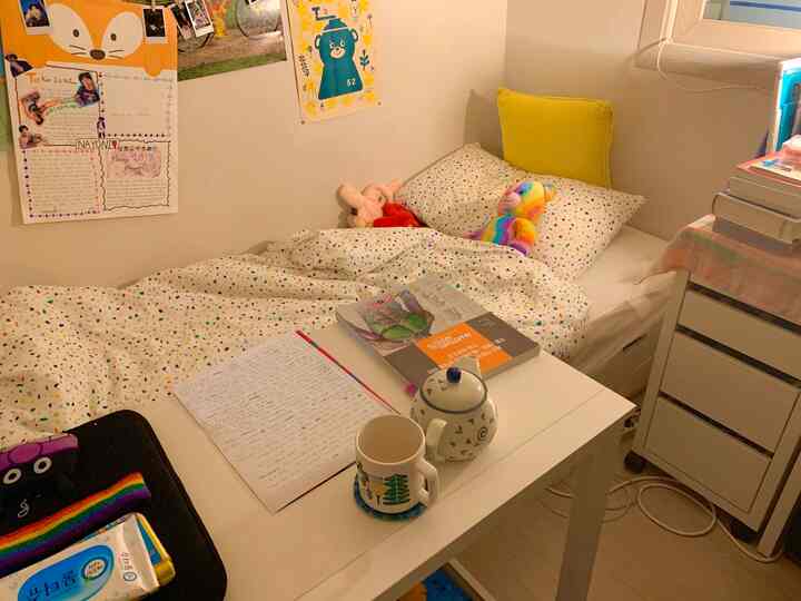A cozy 6-tatami sized bedroom with white walls and furniture, featuring a desk and yellow cushion in a child's room