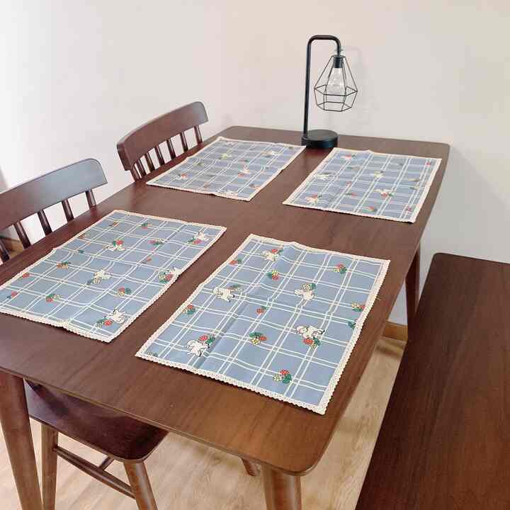 Cozy 4-person kitchen featuring dark wood dining table and chairs with blue floral placemats