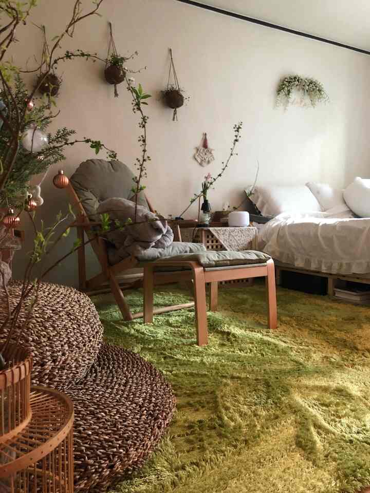 Natural wood tones and white bedding bedroom featuring a green shaggy rug and armchair, creating a cozy atmosphere