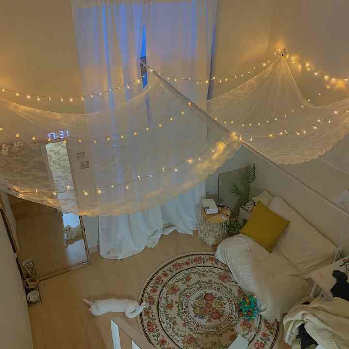 White and lace toned loft-style room featuring sofa, rug, and cozy space for pets