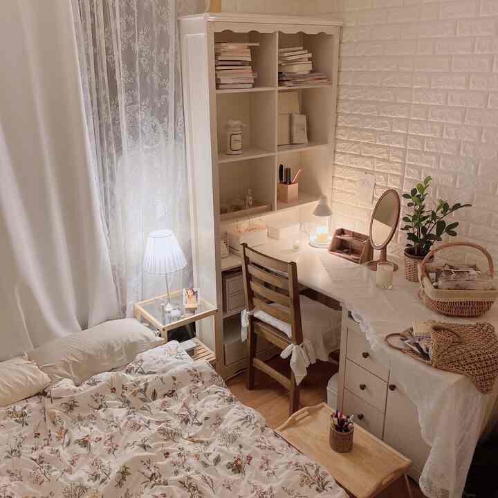 Cozy bedroom featuring white and natural wood tones, a neat home office with desk and bed arranged harmoniously